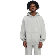 Person wearing a gray hoodie with a brand logo in a snowy forest setting
