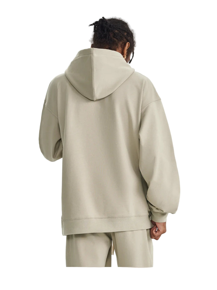 Person wearing a beige hoodie and pants on a light gray background