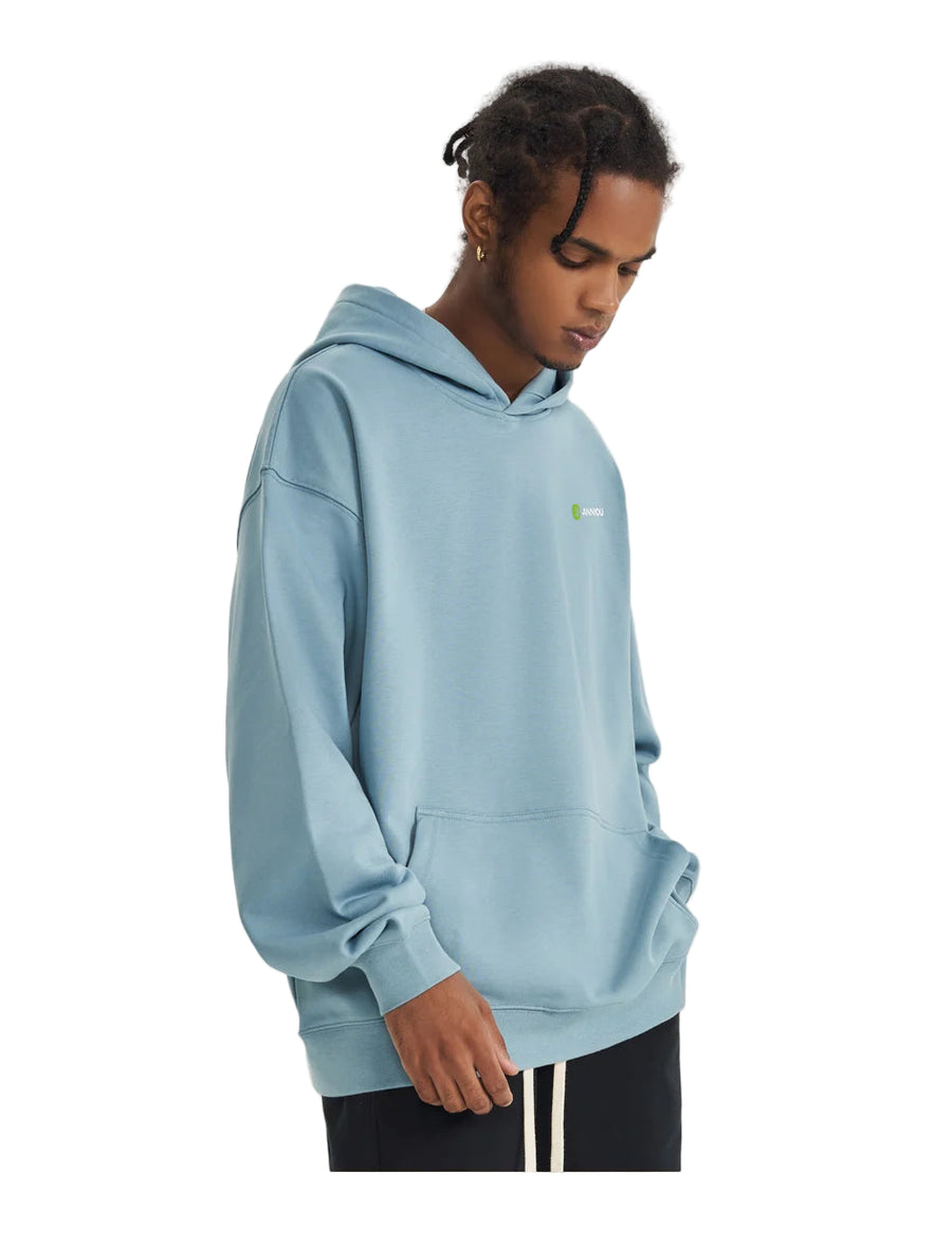 Person wearing a light blue hoodie on a plain background