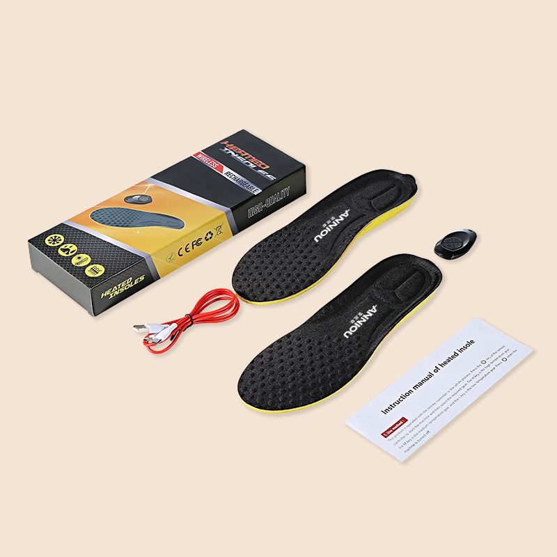 Black heated shoe insoles with packaging, cable, and manual on a beige background
