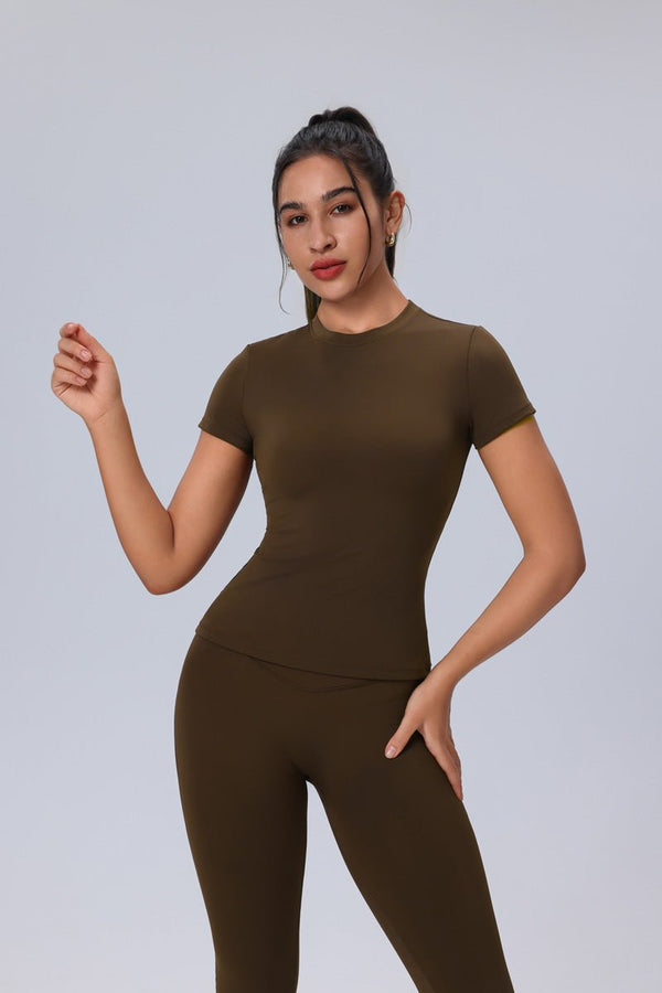 Woman wearing a #brown outfit against a plain background