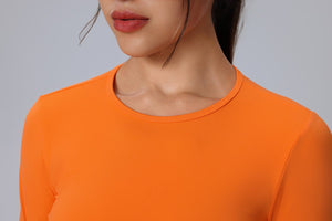 Person wearing an orange long-sleeve sports top design