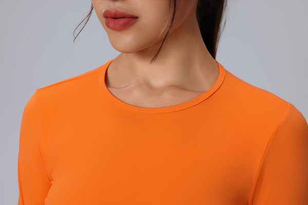 Person wearing an orange long-sleeve sports top design