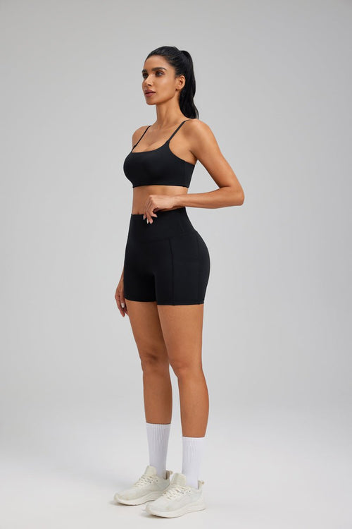 Woman wearing a #black sports bra and high-waisted shorts 