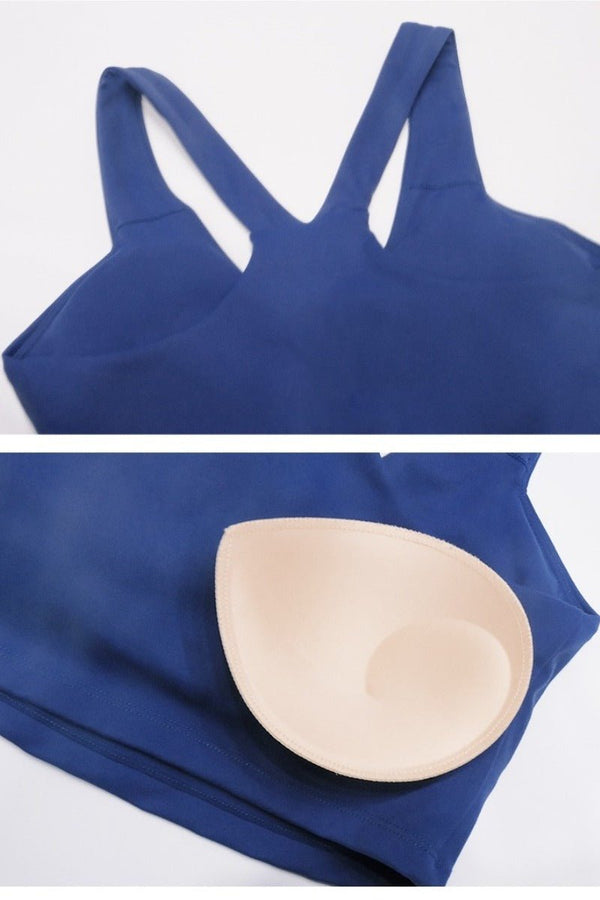 Blue sports bra with a beige silicone pad on a white background
