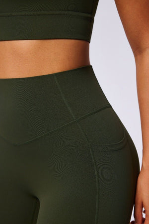 #Green athletic leggings with textured design on a plain background