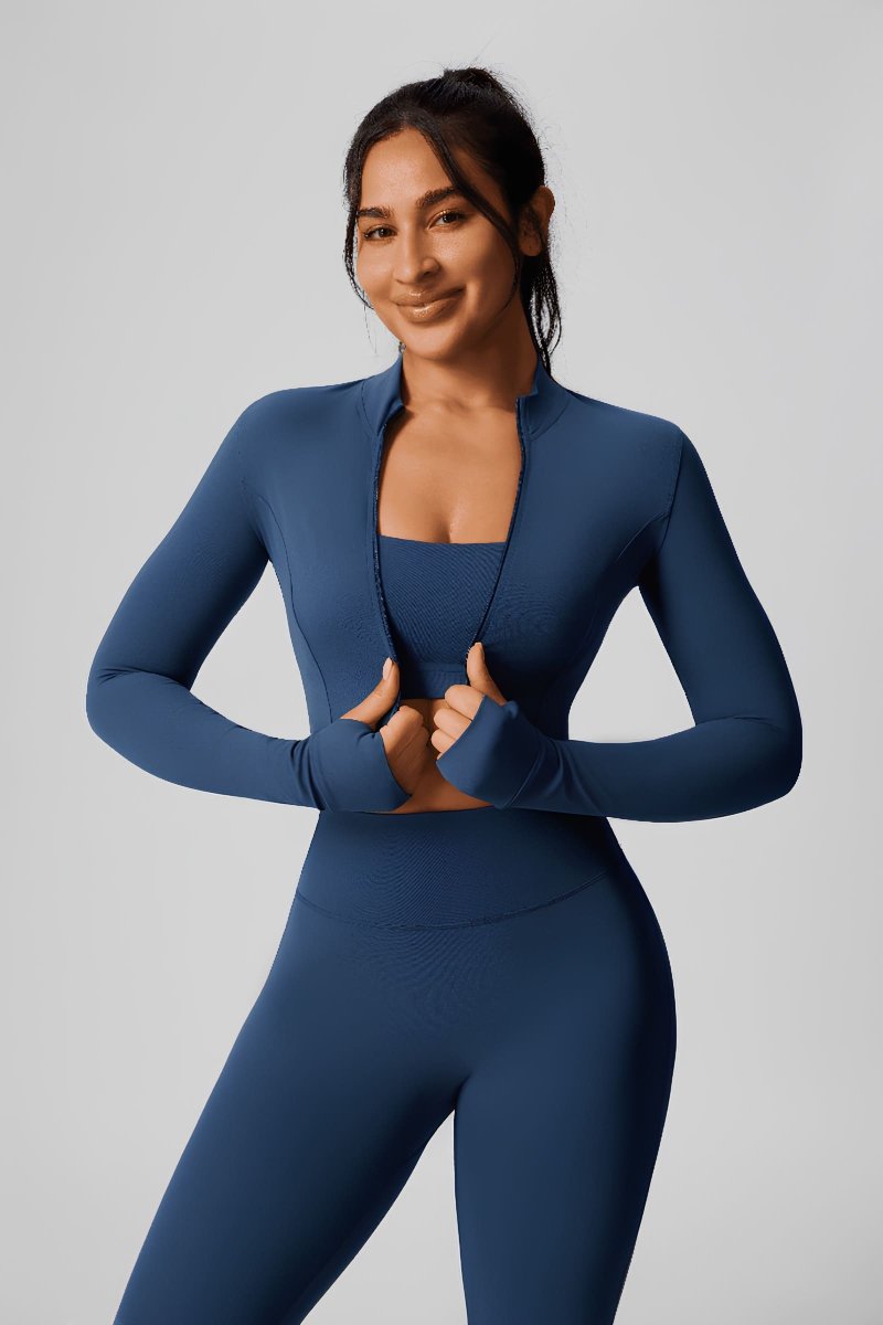 Woman wearing a #navyblue athletic outfit jacket, tank top and leggins