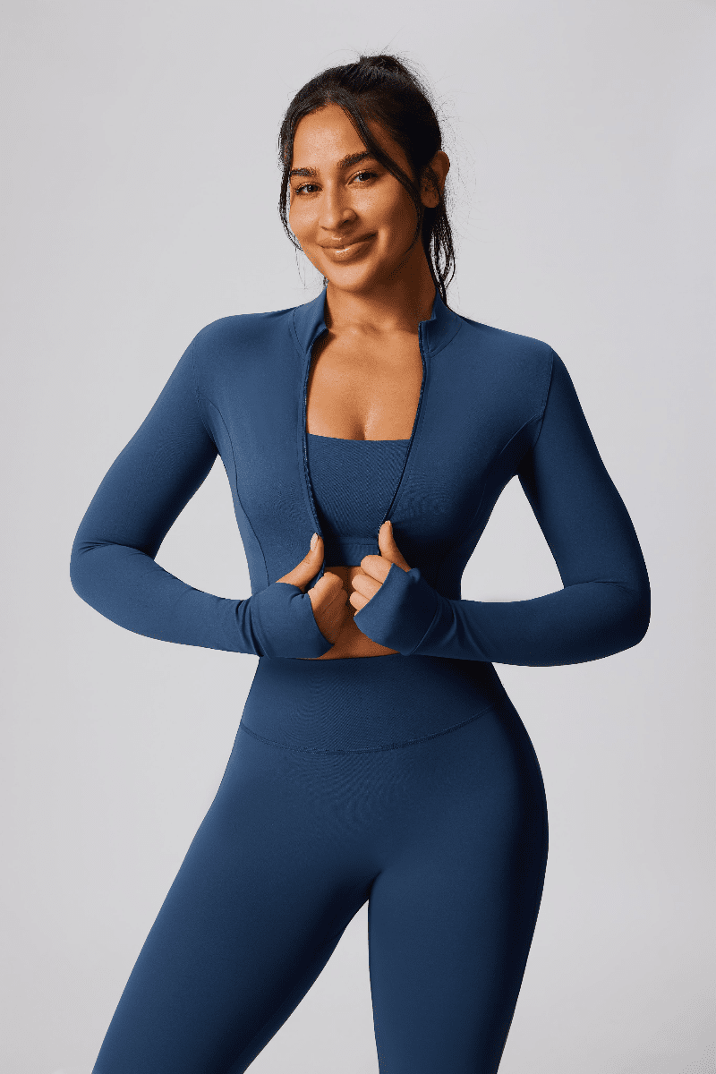 Woman wearing a blue athletic outfit on a plain background