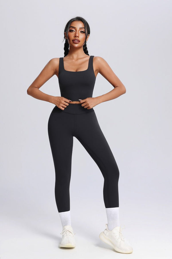Woman wearing a #black athletic outfit on a white background