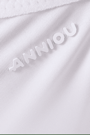 Close-up of a white fabric with 'ANNIOU' branding.