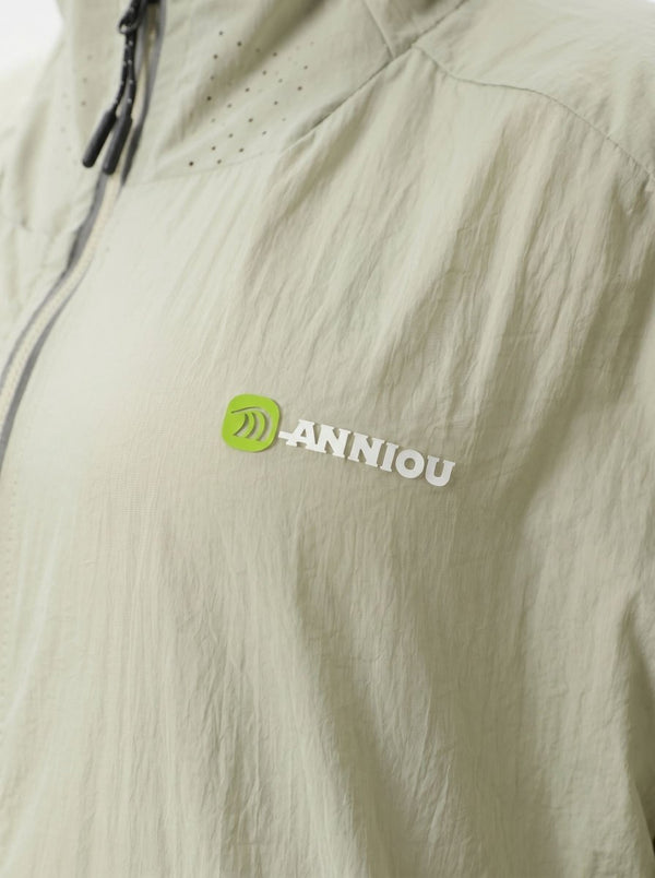 Close-up of a #lightgreen lightweight jacket fabric with a small green and white ANNIOU logo on the chest.