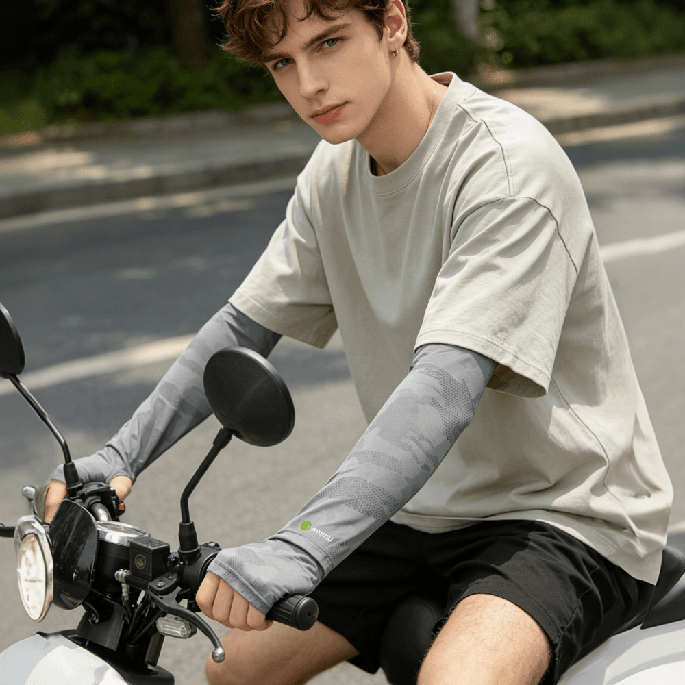 A man wearing loose-fitting sun protection sleeves while riding a bicycle