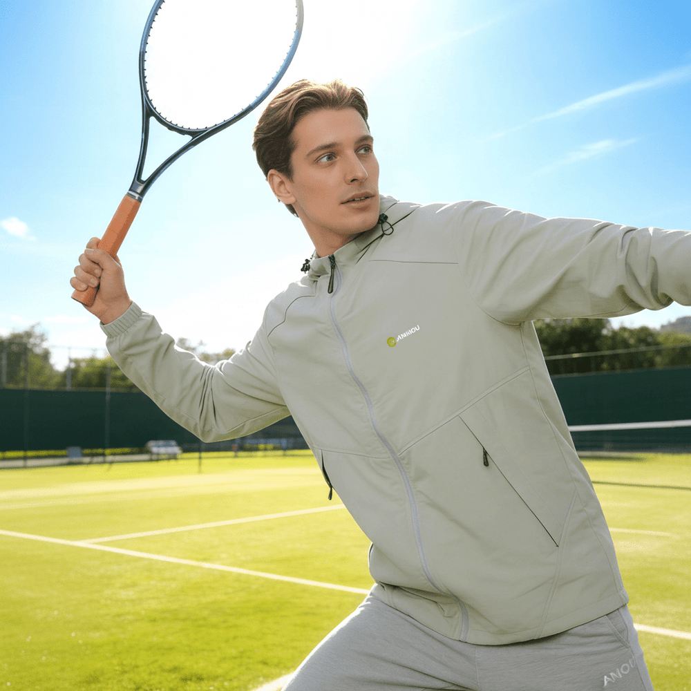 A man is playing tennis wearing an ANNIOU sun-protective hooded jacket