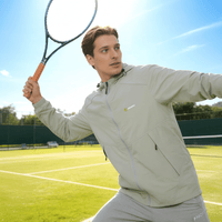 A man is playing tennis wearing an ANNIOU sun-protective hooded jacket