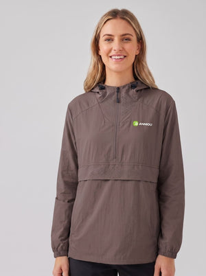 A woman wearing a #brown hooded lightweight UV jacket with a half-zip front and a green and white Anniou logo on the left chest, photographed against a solid gray studio background.