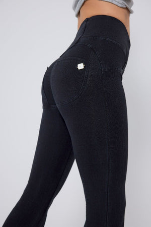 Black jeans worn by a person on a white background