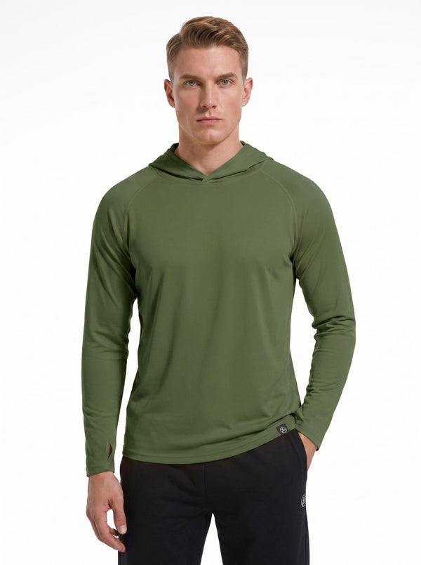 A male model wearing a #dark green hooded long-sleeve performance shirt and black athletic pants stands against a plain white background. 