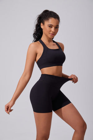 Woman wearing a #black sports bra and shorts with 4 way stretch and UPF 50+ fabric