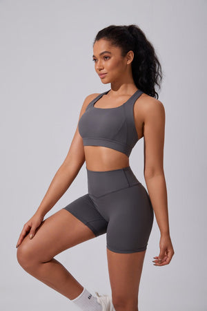 Woman wearing a #gray sports bra and high waist shorts 
