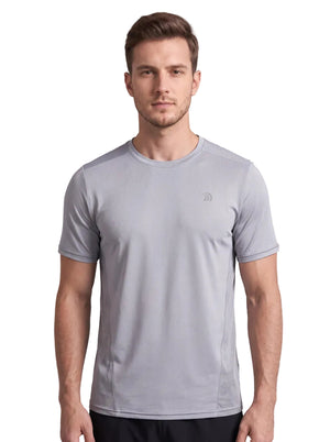 A front-view studio photo of a man wearing a light gray athletic T-shirt with a small subtle logo on the left chest, standing against a plain neutral background