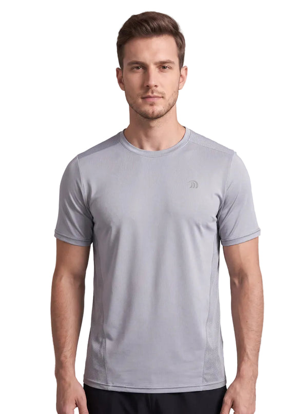 A front-view studio photo of a man wearing a light gray athletic T-shirt with a small subtle logo on the left chest, standing against a plain neutral background