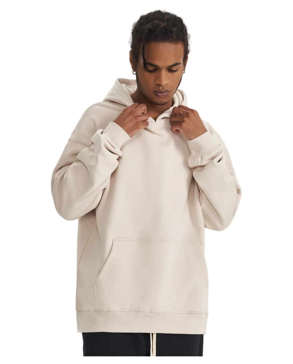 Person wearing a beige hoodie on a light background