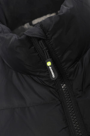 Close-up of a black puffer jacket showing the high collar, quilted fabric texture, and a black zipper pull with a small yellow-green circular logo and white 'ANNIOU' text.