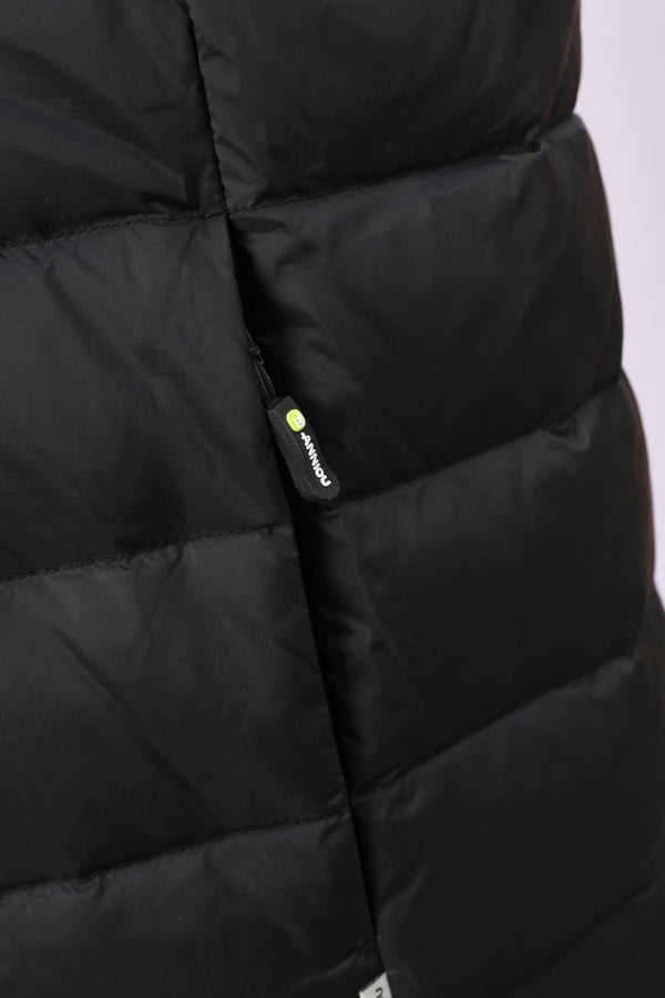Close-up of a black puffer jacket with horizontal quilting and a small black zipper pull featuring a yellow-green dot and white 'ANNIOU' branding.