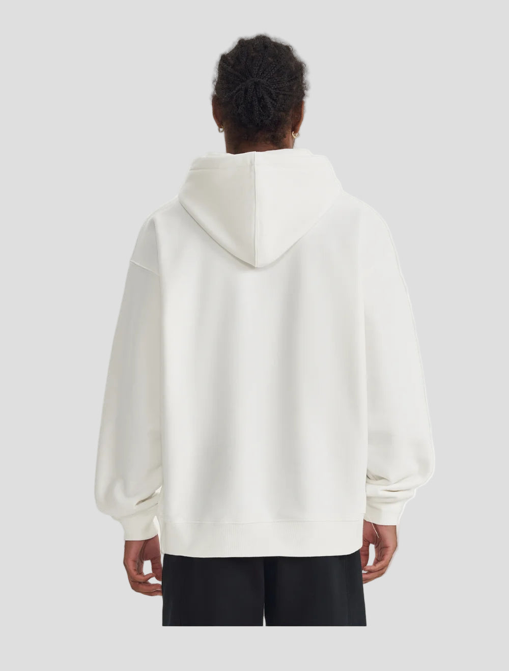 Person wearing a white hoodie from behind on a white background