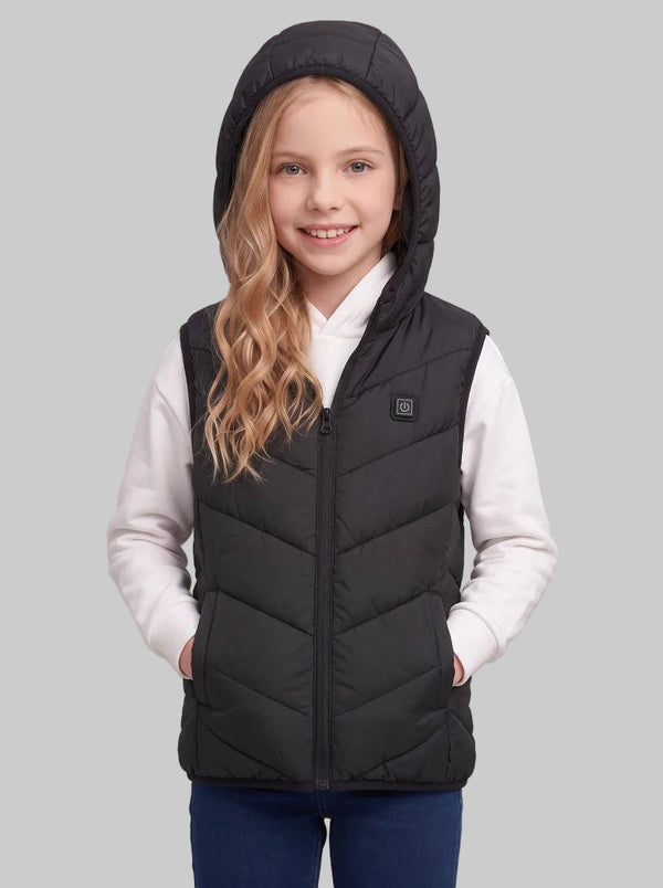 Pre‑teen caucasian girl with hood up on black kids heated vest, both hands in pockets, wearing white hoodie and blue jeans, demonstrate hood wearing look for children winter heating gilet