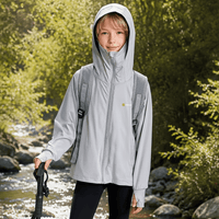 The little boy was exploring outdoors wearing a gray hooded sun protection jacket