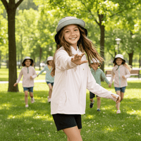 Children wearing light sun-protective clothing played and chased each other in the park