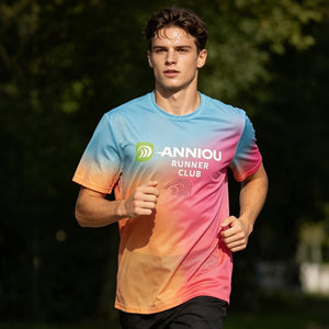 A young man wearing a #rainbow gradient T-shirt is running.