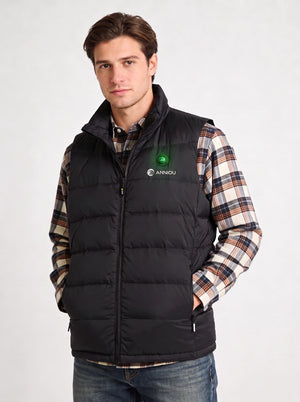 A man wearing a black heated puffer vest over a brown and beige plaid flannel shirt by ANNIOU.