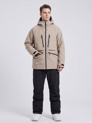 25-year-old British male model wearing #khaki hooded snowboard jacket and black snow pants, light grey studio background, commercial e-commerce product photo