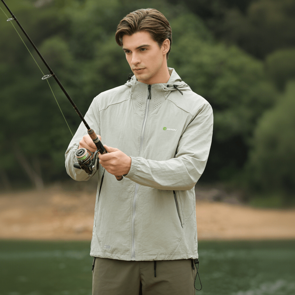 A man wearing an ANNIOU sun-protective hooded jacket while fishing
