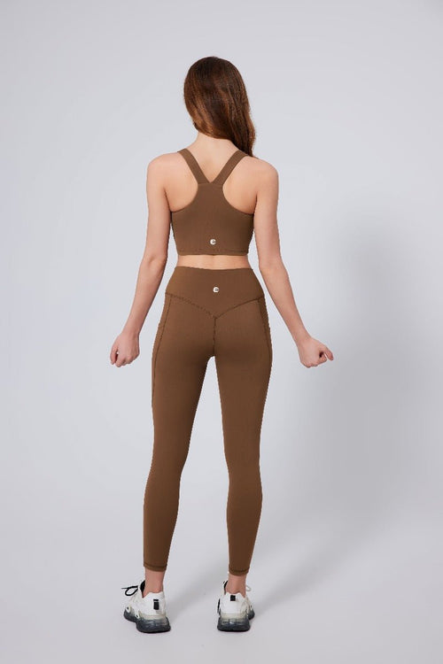Woman wearing a #brown sports bra and leggings racerback Anniou
