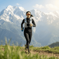 A woman wearing a sports vest is doing a cross-country run outdoors