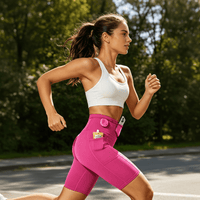 A woman is running outdoors wearing bright rose red compression shorts