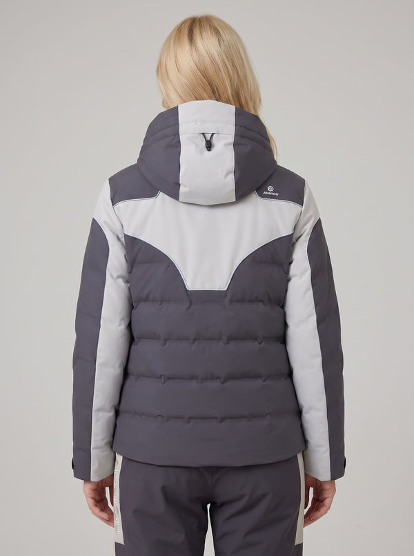 A woman viewed from the back wearing a color-blocked heated puffer ski jacket in dark gray and light gray, paired with matching gray pants with light gray side stripes.