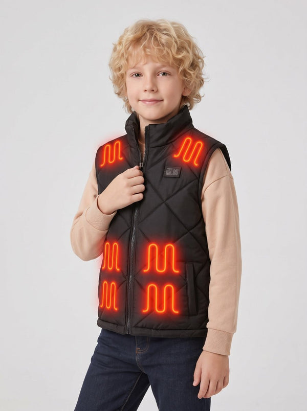 Young boy in black kids heated vest, one hand gripping front zipper, glowing red heating zones on shoulders and chest, light grey studio background, children electric heating vest