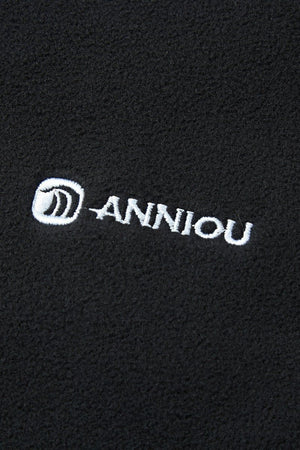 black fabric with 'Anniou' logo embroidered in white.