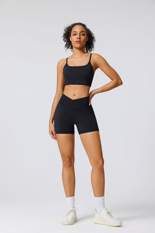 woman wearing a #black seamless sports bra and black criss cross yoga shorts
