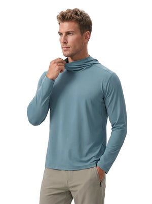Caucasian male model wearing #blue hooded long-sleeve sun protection shirt and khaki trousers, adjusting the neck gaiter, one hand in pocket, plain white background.