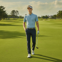 A handsome young man wearing a blue men's sun-protective golf polo shirt stands on the golf course