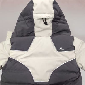A hooded puffer vest in a color-blocked gray and off-white design, featuring a small white circular logo on the left chest with the brand name 'Anniou' underneath with reflective features.