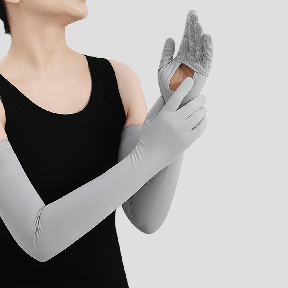 Person wearing gray uv gloves and arm sleeves on a light gray background