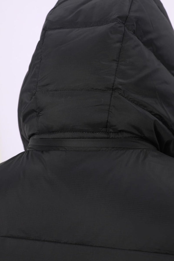 Close-up of the hood and upper back of a black puffer vest, showing quilted stitching and a zippered hood detail 