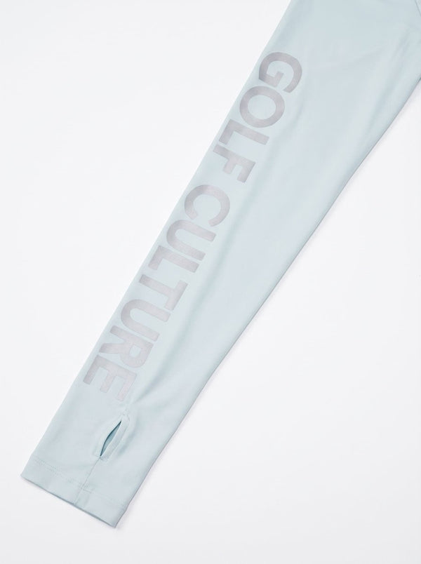 A close-up of a light blue sleeve featuring the word 'GOLF CULTURE' printed vertically in a matching light blue-gray tone, with a small zippered opening near the cuff.