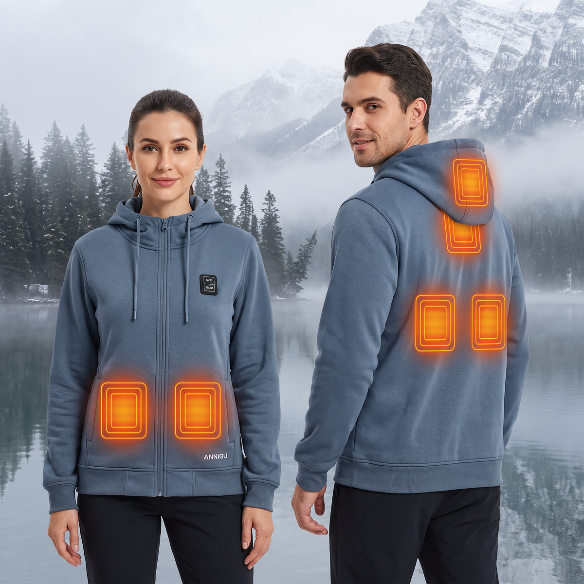 A man and a woman wearing matching blue heated hoodies, shown from the front and back against a misty mountain lake backdrop. The hoodies have glowing orange heat-map overlays indicating heated zones on the chest and upper back.
